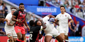 Fiji’s Josua Tuisova tackles England’s Manu Tuilagi in their Rugby World Cup quarter-final.