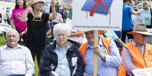 Prominent among the protesters were banners against wind and solar projects.
