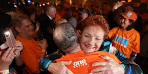 Pauline Hanson embraces a supporter at the One Nation HQ party in Albury.