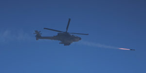 An Israeli Apache helicopter fires a missile.