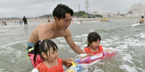 A family plays in the water at Kitaizumi Kaisui beach in Minamisoma,Fukushima Prefecture,after the beach opened to the public for the first time since 2011. 