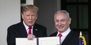US President Donald Trump,left,and Benjamin Netanyahu,Israel's PM hold up a signed proclamation after a meeting at the White House in Washington,DC. 