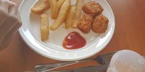 A dinner of chips and chicken nuggets at an aged care home.