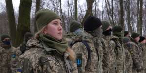 Civilians participate in a Kyiv Territorial Defence unit training in a forest in Ukraine in January.