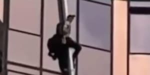 Man free climbs a building in Melbourne.