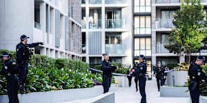 Police combing the unit complex where a man was shot on Monday morning.