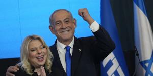 Former Israeli Prime Minister and the head of Likud party,Benjamin Netanyahu and his wife Sara gesture after first exit poll results for the Israeli Parliamentary election at his party’s headquarters in Jerusalem,on Wednesday.
