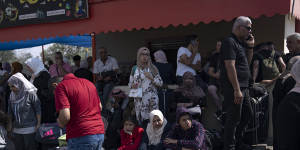 Palestinians wait to cross into Egypt at the Rafah border crossing in the Gaza Strip.