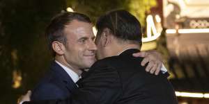 French President Emmanuel Macron and Chinese President Xi Jinping hug in 2019.
