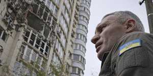 Kyiv Mayor Vitali Klitschko stands in front of an apartment building damaged by a drone that was shot down during a Russian attack on May 8,2023. (AP Photo/Andrew Kravchenko)