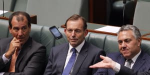 A phone flies past Tony Abbott’s head in parliament.