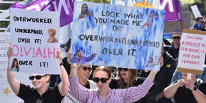 Signs at the rally often conveyed the message that teachers were “underworked,overpaid and over it”.