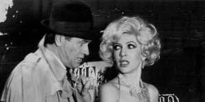 “The Stripper” Terence Donovan as Lt. Al Wheeler and Robyn Moase as Deadpan Dolores in “The Stripper”