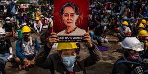 Free the Lady:An anti-coup protester holds up a placard featuring de-facto leader Aung San Suu Kyi on Tuesday in Yangon.