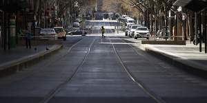 A deserted Bourke Street in Melbourne's CBD. Economists and the RBA say the nation's economic recovery depends on bringing the spread of the coronavirus under control. 