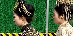 Two young women in traditional Chinese costumes on an electric scooter in east Beijing’s Dongcheng district.