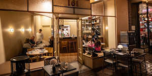 Onice has glowing glass wall lamps,sand-toned walls and padded banquette seating.
