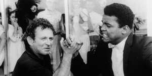 Novelist Norman Mailer arm wrestles with heavyweight champion Muhammad Ali in 1965.