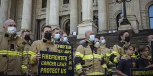 Firefighters on the steps of the state parliament last month,urging the government not to expand the compensation scheme. 