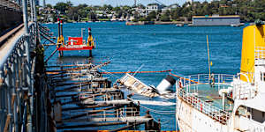 The ferry under water beside its mooring on Balls Head Bay at Waverton.