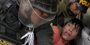 An anti-government protesters who traveled to the capital from across the country to march against Peruvian President Dina Boluarte,is detained and thrown on the back of police vehicle during clashes in Lima.