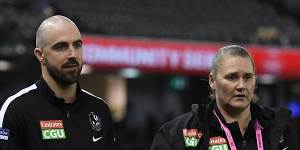 Steele Sidebottom (left) walks around the boundary line on Friday night. 