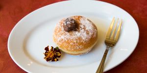 Sugar-dusted bombolini (doughnut).