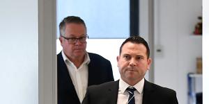 A-League boss Greg O'Rourke flanks FFA chief executive James Johnson as he prepares to enter Tuesday's press conference.