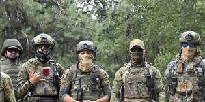 Belarusian soldiers of the Special Operations Forces and mercenary fighters from Wagner private military company pose for a photo while on manoeuvres near the border city of Brest,Belarus. 