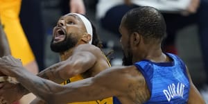 Patty Mills,who starred for the Boomers,is fouled by Kevin Durant.