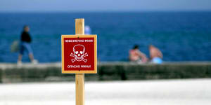 The ‘Danger Mines’ warning sign is pictured at a local beach in Odesa,southern Ukraine.