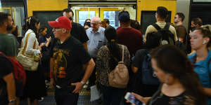 Commuters pile into a packed train at Kogarah during the morning peak on Wednesday amid high cancellations due to industrial action.