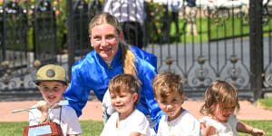 Jamie Kah poses with the Dean Holland Trophy and his four children after winning the 2024 Newmarket Handicap.
