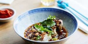 Steamed barramundi wrapped in salted cabbage and served with soy dressing.