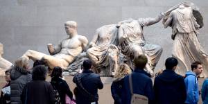 Visitors look at The Parthenon Marbles,also known as the Elgin Marbles in the British Museum.