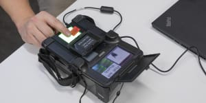 Matthias Marx,a security researcher at the Chaos Computer Club,uses a SEEK II to scan his fingerprint in Hamburg last week.