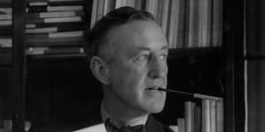 English author Ian Fleming (1908-1964) in his study with one of the series of James Bond novels that he wrote.