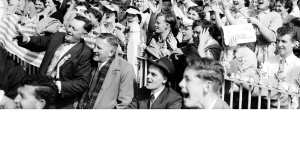 A sea of hats,suits and ties and best frocks. An immaculately dressed crowd watches the game.