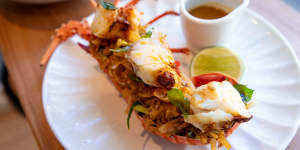 The signature lobster kottu comes with a jug of bisque-like curry sauce on the side.