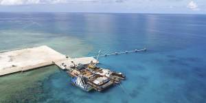 Ships carrying building materials docked at a new beach ramp at the Philippine-claimed island of Pag-asa,also known as Thitu,in the South China Sea in June,2020.