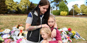 Felicity Miller with her daughters,Amelia and Felicia. Amelia,9,was at the school when a gust of wind lifted an inflatable castle ten metres into the air.
