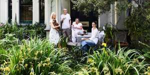 Isabella,holding Bowie,with Ross,Natalie and Sascha in the lush garden,which is planted with camellias,orchids,peonies and tulips.