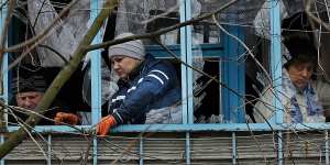 Residents clean up the damage from a missile attack in Kramatorsk.