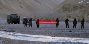 Chinese troops hold a banner which reads"You've crossed the border,please go back"in Ladakh,India,in 2013.