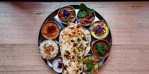 The vibrant thali tray of curries is just one course of the tasting menu. 