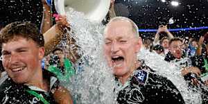 Michael Maguire (right) celebrates the Broncos’ victory.
