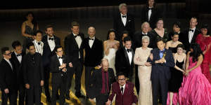 The cast and crew of Everything Everywhere All at Once accept the award for best picture.