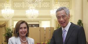 US House Speaker Nancy Pelosi,left,and Singaporean Prime Minister Lee Hsien Loong shake hands at the Istana Presidential Palace in Singapore. Pelosi arrived in Singapore early on Monday,kicking off her Asian tour.