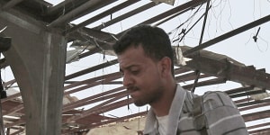 A Yemeni man walks on the rubble of a petrol station after it was hit by Saudi-led airstrikes in Sanaa,Yemen,late last month.