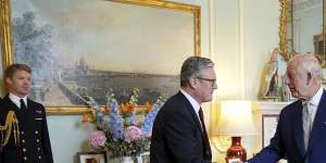 King Charles III,right,shakes hands with new British Prime Minister Sir Keir Starmer as the pair meet at Buckingham Palace.